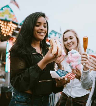 Friends at a fair sharing snacks